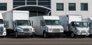 Commercial trucks parked outside a building