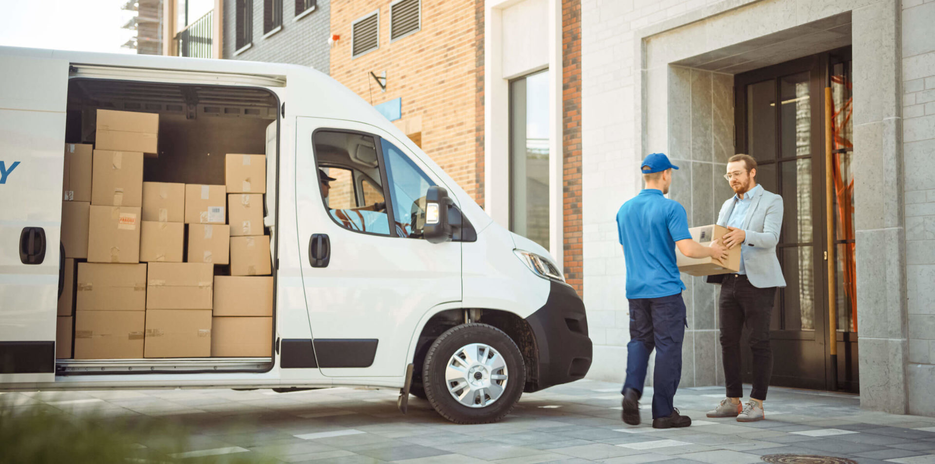 man deliverying packages with package delivery truck